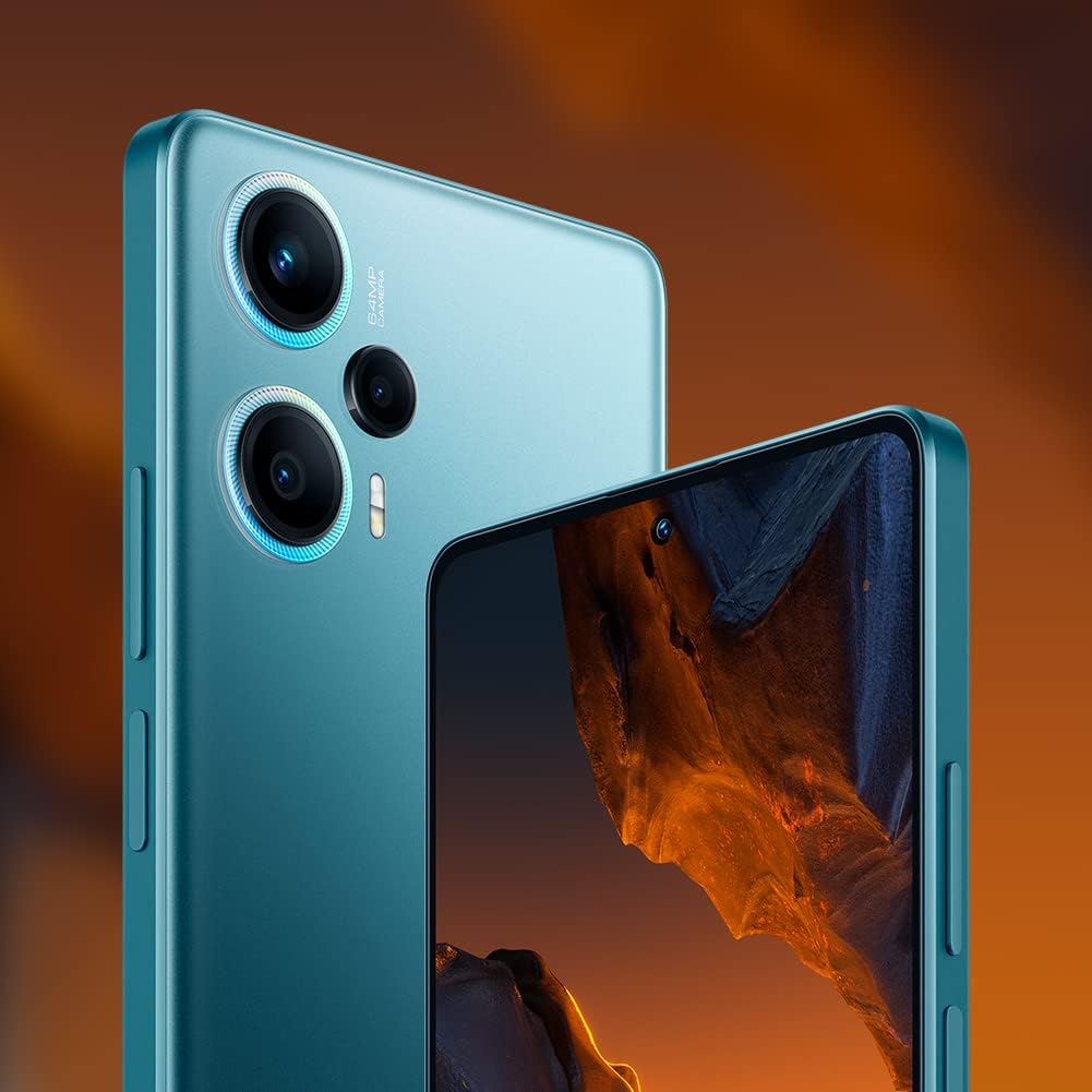 The image shows a close-up of a Xiaomi Poco F5, highlighting the rear camera module and part of the front display with an image on it. The smartphone has a prominent dual-lens rear camera with the lenses encircled by metallic-looking rings, and there appears to be a smaller third camera or sensor below them, alongside an LED flash. The back panel of the phone has a matte finish.
The front display shows a portion of an image that seems to be a natural landscape; you can see the edge of a rocky formation on the screen. The design of the phone suggests it is modern and likely oriented towards users who are interested in photography or high-quality imaging, inferred from the prominent camera setup. The power button is visible on the side, and the color of the phone is a kind of light blue or teal.