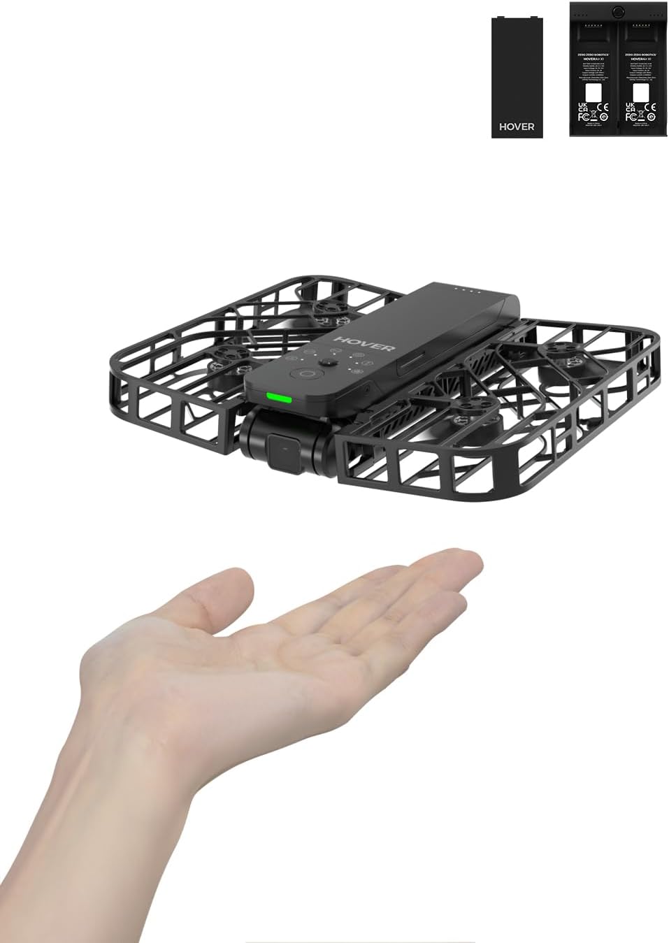 This image features a compact, HoverAir X1 Drone with a protective frame around its propellers. The drone is hovering above an open human hand, indicating its small size and the ability to take off or land on a palm.