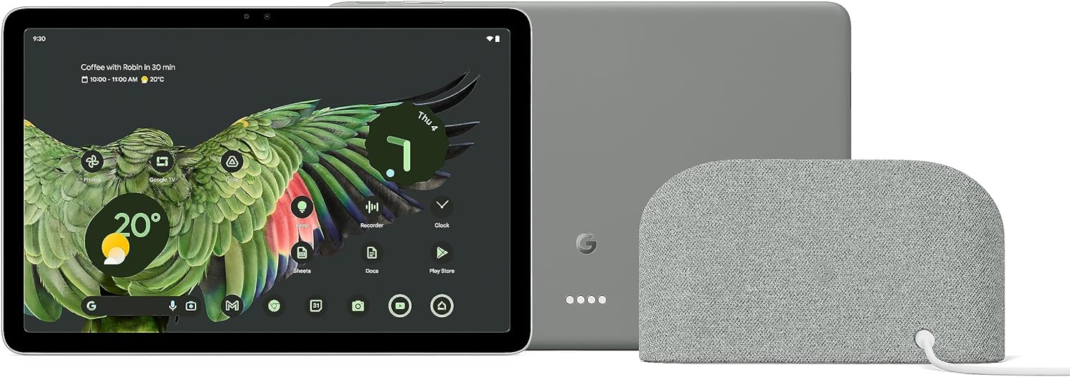 The image shows two devices, most likely electronic gadgets from the same company, indicated by the visible logo. The device on the left appears to be a tablet with its screen displaying a colorful wallpaper featuring a parrot and various app icons that suggest the tablet runs on the Android operating system. This is also indicated by the presence of Google apps like Photos, Google TV, Keep, Sheets, and the Google Play Store on the screen. 