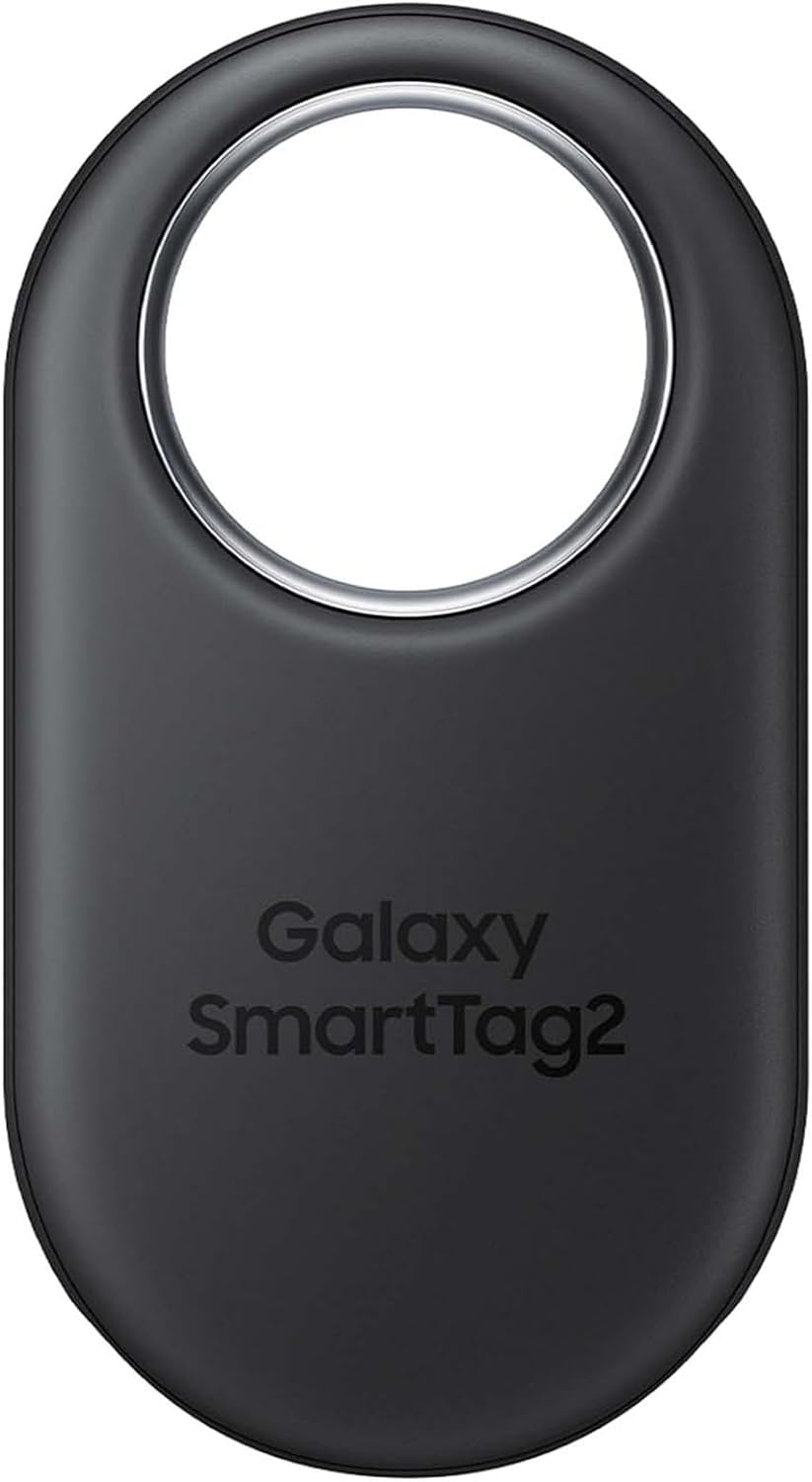 The image shows a Samsung Galaxy SmartTag2, which is a small, oval-shaped, Bluetooth-enabled tracking device. It can be attached to personal items like keys, bags, or even pets, allowing users to locate these items through a smartphone app if they get misplaced. This device helps users find their lost items by signaling their location. The design features a hole at the top for easy attachment to various items, and it has the product name printed on the front.