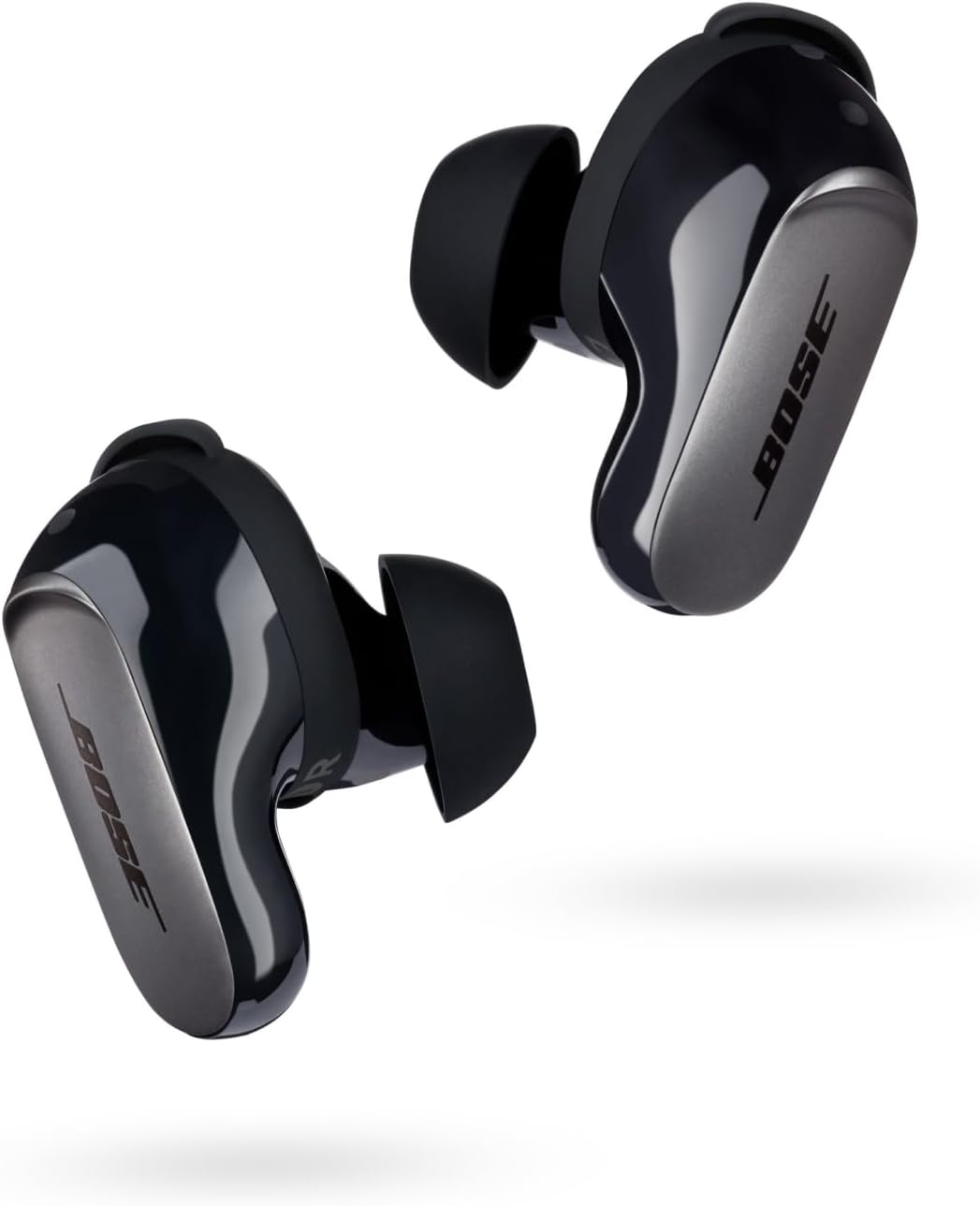 The image shows a pair of wireless earbuds, specifically the Bose QuietComfort Ultra. They are designed for audio playback and potentially for making phone calls, as many such devices include built-in microphones. The earbuds have an in-ear design with tips that are inserted into the ear canal, providing a snug fit that often helps with noise isolation. The design appears modern and sleek, indicating that they are likely a premium product.