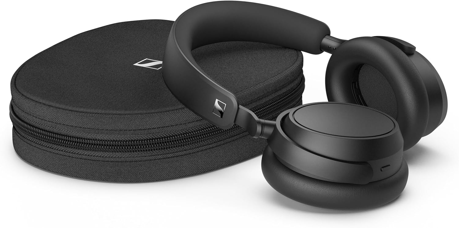 This image shows a pair of Sennheiser Accentum Plus headphones next to their carrying case. The headphones are black with a sleek, modern design, featuring what looks like a cushioned headband and ear cups for comfort. The carrying case appears to be a hard shell with a zipper, also in black, which helps protect the headphones during transport or when not in use. These types of headphones are commonly used for listening to music, podcasts, or other audio content, and they may offer features like noise-cancellation or wireless Bluetooth connectivity.