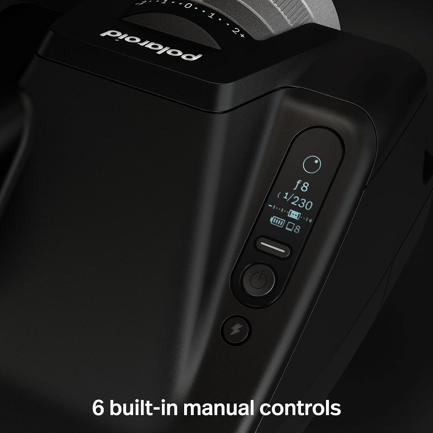 The image shows a close-up view of a part of a Polaroid i-2 with a focus on its manual control interface. This interface includes several buttons and a small display showing camera settings such as aperture (f8) and shutter speed (1/230).